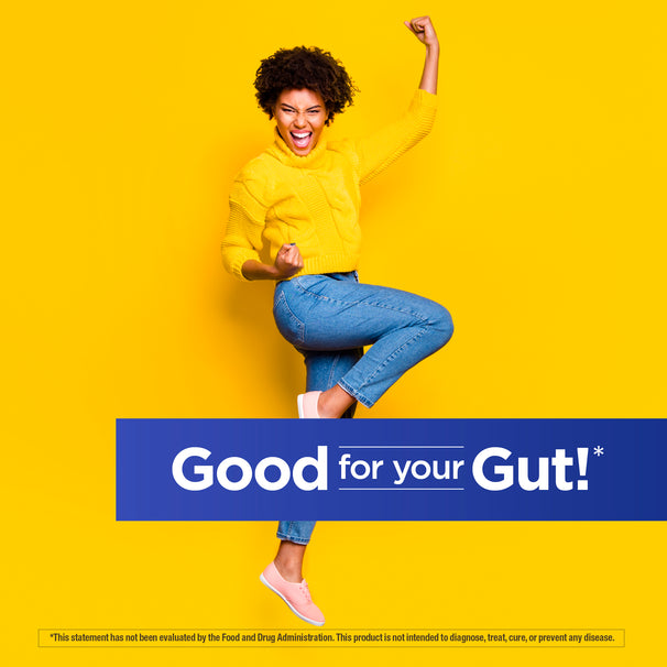 View 5 Young woman in yellow sweater and jeans cheers excitedly with text 'Good for your Gut!'. Daily Balance Probiotic.